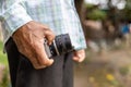 Close-up view of the elderly hand holding an old film camera. Royalty Free Stock Photo