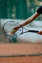 Close-up view of hand female tennis player holding ball and racket preparing to serve Royalty Free Stock Photo