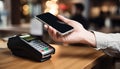 Mobile phone, touch a credit card reader on the counter bar. Royalty Free Stock Photo