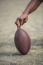 Hand holding american football ball Royalty Free Stock Photo