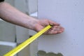 Close up view of the hand holding the measuring tape next to the Royalty Free Stock Photo