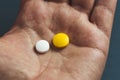 close-up view of a hand holding two pills Royalty Free Stock Photo