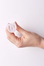 Close up view of hand holding white rubber menstrual cup, changing its shape, available for usage during menstruation, reusable Royalty Free Stock Photo