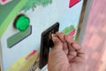 Close up view of hand of human inserting coin in to the old vending machine,Shallow depth of field, Automatic Machine Royalty Free Stock Photo