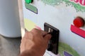 Close up view of hand of human inserting coin in to the old vending machine,Shallow depth of field, Automatic Machine Royalty Free Stock Photo