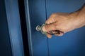 Close-up view of hand with key unlocking and opening door Royalty Free Stock Photo