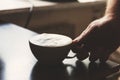 Close up view of the hand of a man working in a coffee house preparing espresso coffee waiting for the coffee machine to finish p Royalty Free Stock Photo