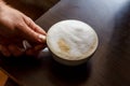 Close up view of the hand of a man working in a coffee house preparing espresso coffee waiting for the coffee machine to finish p Royalty Free Stock Photo