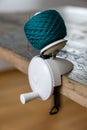 Close up view of a hand-operated knitting roll or wool thread ball winder and knitting umbrellla