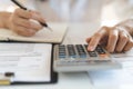 Close up view hand of person calculating income balance