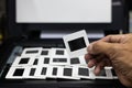 Close-up view of the hand picked up a lot of slide films arranged in rows