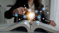 Business concept of idea generation with light bulb in open book and digital connection icons for creativity, innovation Royalty Free Stock Photo