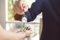 Hand of property realtor / landlord giving key house to buyer / tenant Royalty Free Stock Photo