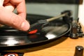 Close up view of hand putting vinyl record on running to hear music