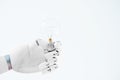 close-up view of hand of robot holding light bulb Royalty Free Stock Photo