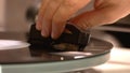 Close-up view of hand which holding a gramophone`s needle.