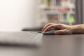 Close up view of a hand with a wireless mouse. Work from home, online study