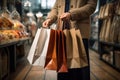 Close-up view of hands carrying shopping bags, symbolizing a fruitful shopping excursion