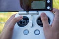 Hands Operating Drone Remote Control with Smartphone Display Royalty Free Stock Photo