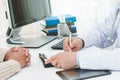 Close up view hands of doctor writing information of patient for diagnosis disease