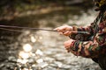 Close-up view of the hands of a fly fisherman working the line and the fishing rod Royalty Free Stock Photo