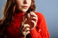 Close up view of hands holding cocktail on party. Woman in a red sweater holds a glass with champagne Royalty Free Stock Photo