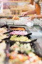 Close up view of hands picking prepared meals Royalty Free Stock Photo