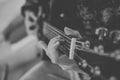 Close up view of hands playing guitar in black and white. Young woman playing guitar. Royalty Free Stock Photo