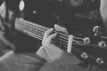 Close up view of hands playing guitar in black and white. Young woman playing guitar. Royalty Free Stock Photo