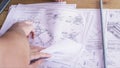 Close up view on hands pointing at technical drawings lying on the table. Man hands indicating some details in papers Royalty Free Stock Photo