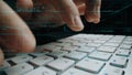 Close-Up View of Hands Typing Code on a Laptop Keyboard with Overlayed Programming Language Text and Data Visualization Royalty Free Stock Photo