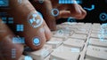 Close-Up View of Hands Typing on a Keyboard Surrounded by Futuristic Digital Data Visualization Elements in a Tech-Savvy Royalty Free Stock Photo