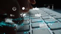 Close-up View of Hands Typing on Laptop Keyboard Surrounded by Digital Graphs and Data Visualizations Representing Royalty Free Stock Photo