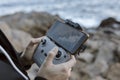 Close up view of the hands of a young man operating a drone over the sea Royalty Free Stock Photo