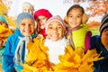 Close up view of happy cute kids with leaves bunch Royalty Free Stock Photo