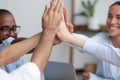 Close up view happy diverse business team giving high five