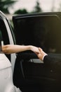 Happy groom helping his beautiful bride out of the wedding car. Royalty Free Stock Photo