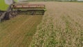 A close-up view of a harvester cutting wheat in a field. Royalty Free Stock Photo