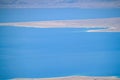 Close up view of a hazy Dead Sea and its salt deposits