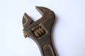 Close-up view of the head of an old rusty adjustable wrench on white background. Old rusty iron wrench for turning screws Royalty Free Stock Photo