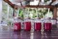 close up view of for healthy juice in small jars on the table. Made of watermelon, orange and blackberries. Home made, healthy