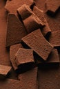 Heap of chocolate bars in cocoa powder