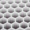 A close up view of a hexagonal honeycomb structure made of white material Royalty Free Stock Photo
