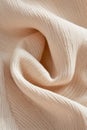 This close-up view highlights a structured geometric knitted texture in beige, enhanced by ultra-sharp lighting that