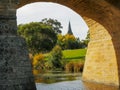 Close up view of the historic old stone bridge and the spire of st john`s catholic church Royalty Free Stock Photo