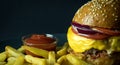 Close up view of homemade cheeseburger with sesame on bun, french fries and ketchup isolated on black Royalty Free Stock Photo