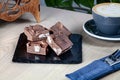 Close up view on homemade chocolate Fudge sugar candy with coffee on wooden table. Royalty Free Stock Photo