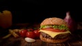 Close up view of homemade tasty beef burger with ingredients and french fries Royalty Free Stock Photo