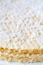 Close up view of homemade waffle cake with condensed milk and coconut flakes. Sweet background Royalty Free Stock Photo