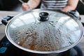 Close up view of hot pot and cover with hot water steam . Shabu Shabu is style beef in hot pot dish of thinly sliced meat